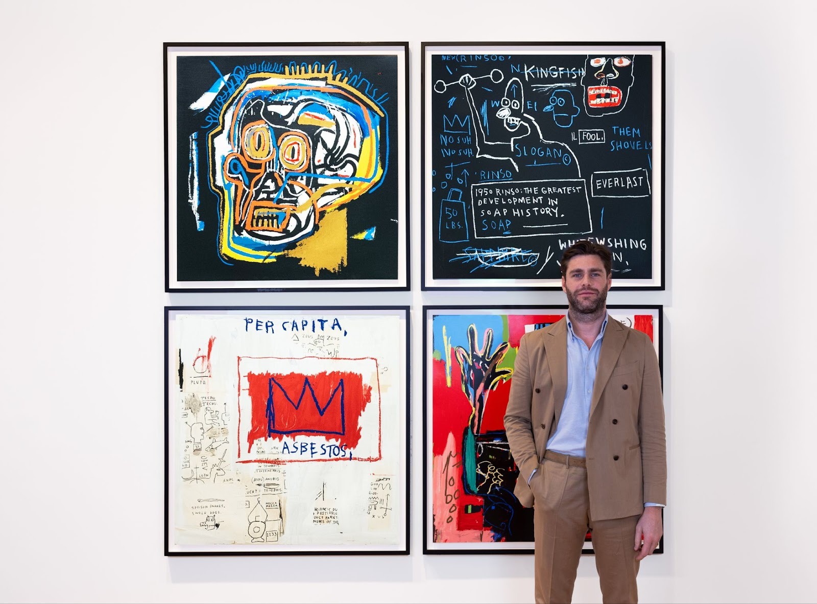 Mathew Lord, Director (Middle East), ready to provide art investment consulting, as he stands in front of Basquiat&rsquo;s portfolio of four Head; Rinso; Per Capita; and Ernok