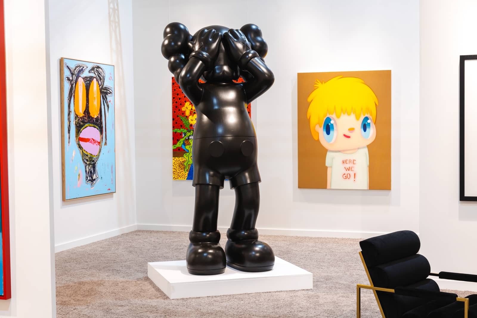 A life size KAWS statue, At This Time (2016), Edition of 3, displays prominently at Maddox Gallery.
